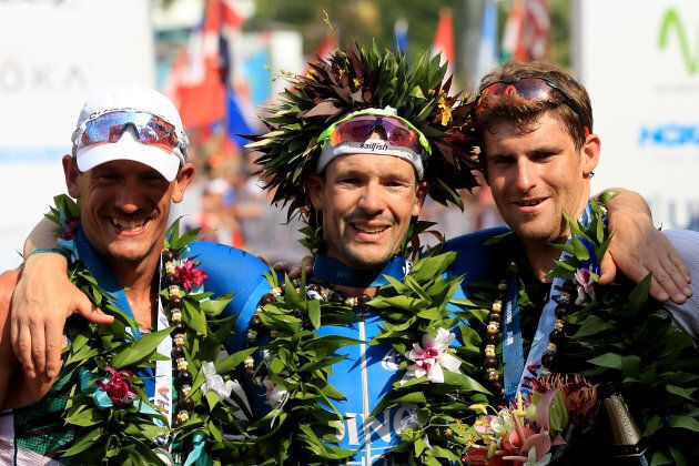 Patrick Lange of Germany (centre) celebrates after winning the IRONMAN World Championship along with Lionel Sanders (left) who finished second and David McNamee (right) who finished third on October 14, 2017 in Kailua Kona, Hawaii. (Sean M. Haffey/Getty Images for IRONMAN)