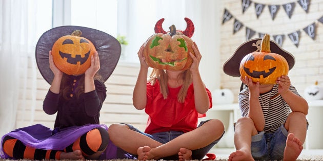 Children playing with Halloween pumpkins.