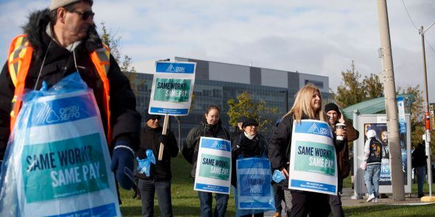 Striking faculty members stand on the picket line outside of Humber College in Toronto on Oct. 16, 2017.