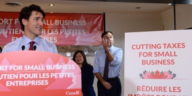 Prime Minister Justin Trudeau speaks to members of the media as Finance Minister Bill Morneau looks on at a press conference on tax reforms in Stouffville, Ont., on Oct. 16, 2017.