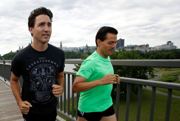 Canada's Prime Minister Justin Trudeau runs with Mexico's President Enrique Pena Nieto across the Alexandra Bridge from Ottawa to Gatineau, Que. June 28, 2016.