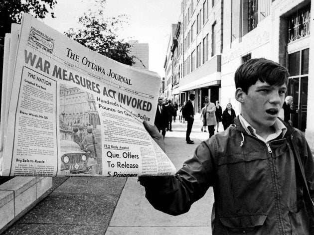 A newsboy holds up a newspaper with a banner headline reporting the invoking of the War Measures Act, in Ottawa, Oct. 16, 1970 the first time Canada had invoked the act in peacetime. The act was put into effect following the kidnapping of British diplomat James Cross and Quebec Labour Minister Pierre Laporte by the terrorist FLQ.