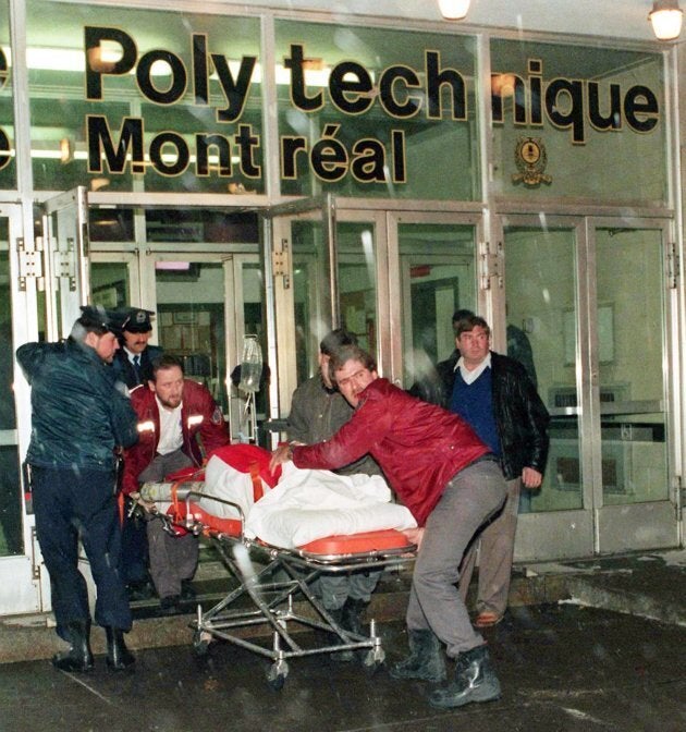 An injured person is wheeled away from the University of Montreal after a gunman, Marc Lepine, opened fire in a packed classroom in Montreal on Dec. 6, 1989.