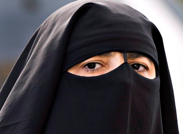 A woman wears a niqab as she walks in Montreal on Sept. 9, 2013.