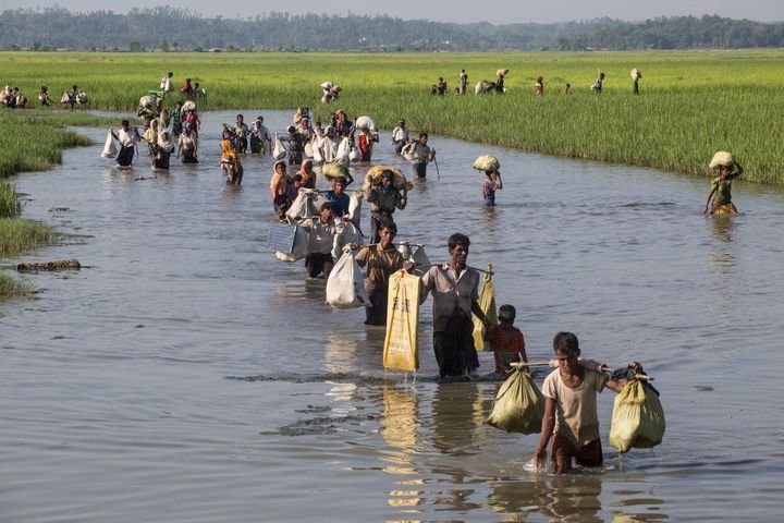 On Oct. 16, 2017, Rohingya refugees including women and children cross into Bangladesh at Palong Khali in Cox's Bazar district. Between 10000 and 15000 newly arrived Rohingya refugees fleeing Myanmar crossed into Bangladesh, and are stuck in Palong Khali in Cox's Bazar district, approximately two kilometres from the border with Myanmar.