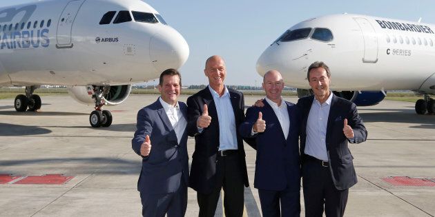 (L-R) Pierre Baudoin, Bombardier's chairman of the board, Tom Enders, president and chief executive officer of Airbus, Alain Bellemare, president and chief executive officer of Bombardier, and Fabrice Bregier, Airbus chief operating officer and president of commercial aircraft, pose in front of an Airbus A320neo aircraft and a Bombardier C Series aircraft during a news conference to announce their partnership on the C Series aircraft program, in Colomiers near Toulouse, France, Oct. 17, 2017.