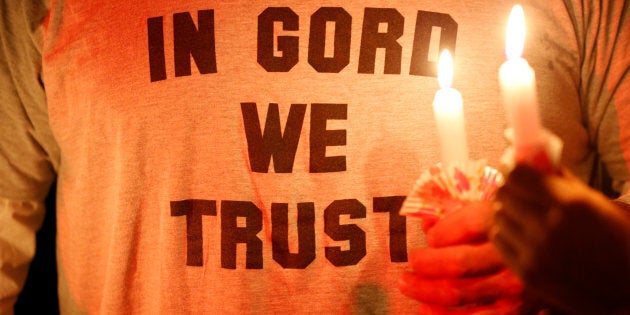 People hold candles during a vigil for the late Tragically Hip frontman Gord Downie in Kingston, Ont. on Oct. 18, 2017.