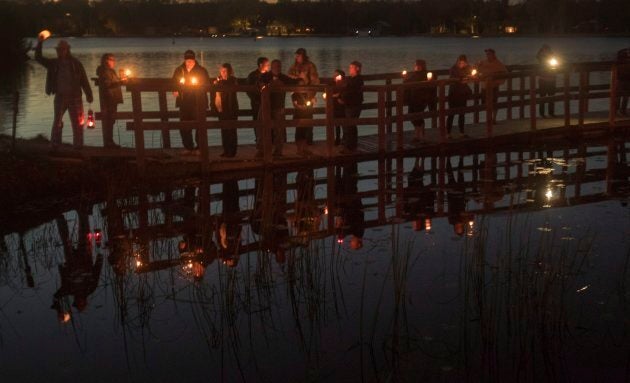 Fans of the Tragically Hip gather for a candlelight vigil by the water's edge in Bobcaygeon, Ont. to pay tribute to singer Gord Downie.