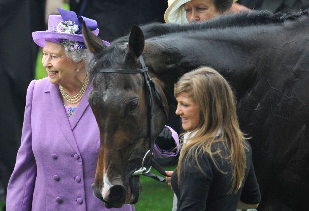 Queen Elizabeth smiles as she stands with her horse Estimate after it won the Gold Cup during Ladies' Day at the Royal Ascot horse racing festival at Ascot, southern England, June 20, 2013.