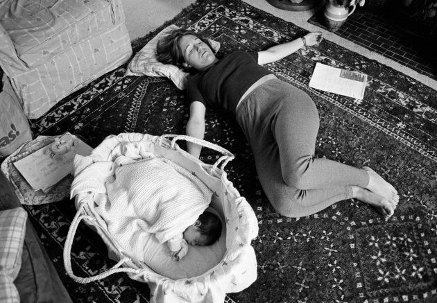 A young mother grabs a few minutes to exercise her pelvic floor muscles three weeks after giving birth. From a documentary series about the first year a child's life. (In Pictures Ltd./Corbis via Getty Images)