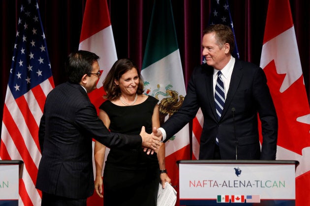 Mexico's Economy Minister Ildefonso Guajardo (L) and U.S. Trade Representative Robert Lighthizer (R) shake hands as Canada's Foreign Minister Chrystia Freeland looks on at the close of the third round of NAFTA talks involving the United States, Mexico and Canada in Ottawa, Sept. 27, 2017.