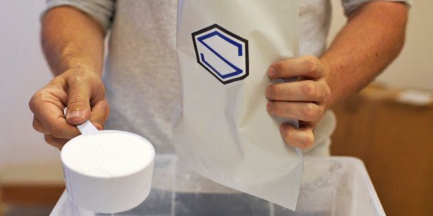 Soylent CEO Rob Rhinehart pours maltodextrin into a bag on Sept. 9, 2013. (Josh Edelson/AFP/Getty Images)