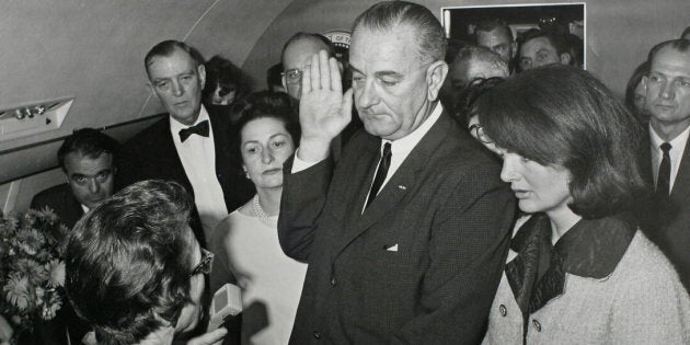 U.S. Vice President Lyndon B. Johnson taking the presidential oath of office next to President John F. Kennedy's widow first lady Jacqueline Bouvier Kennedy aboard Air Force One on November 22, 1963.