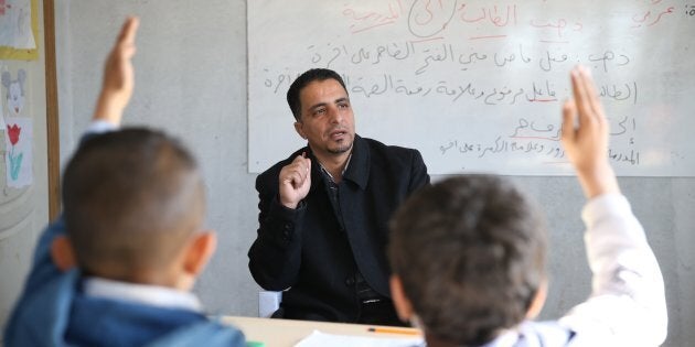 44-year-old Syrian refugee Hudur Omar Ilgeya lectures the refugee children at a temporary education centre in Reyhanli District of Hatay, Turkey on Nov. 23, 2016.