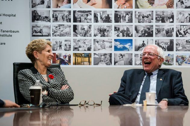 U.S. Sen. Bernie Sanders and Ontario Premier Kathleen Wynne smile during a visit to Mount Sinai Hospital as part of a cross-border tour of the Canadian health care system, in Toronto on Saturday.