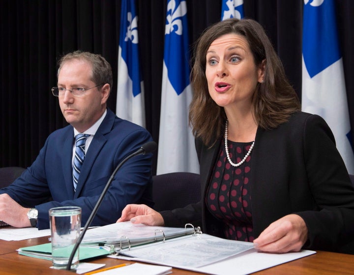 Quebec Justice Minister Stephanie Vallee provides further details about how the government's controversial Bill 62 will be implemented at the legislature, as Justice Minister Yan Paquette, left, looks on in Quebec City, Tuesday, Oct. 24, 2017.