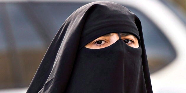 A woman wears a niqab as she walks Monday, Sept. 9, 2013 in Montreal.