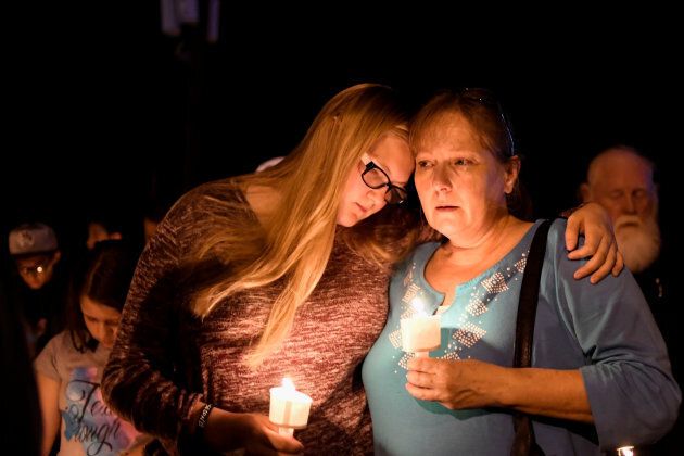 Local residents embrace during a candlelight vigil for victims of a mass shooting in a church in Sutherland Springs, Texas, on Sunday.