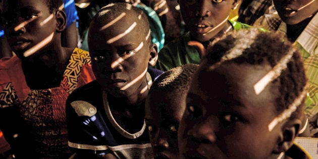 Sunlight is filtered by reed walls as it streams into a classroom as students attend a mathematics class at the Upper Nile primary school in the Protection of Civilians (PoC) site in Bentiu, South Sudan, Monday 1 May 2017.