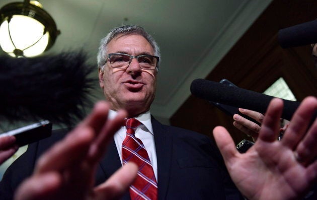 Quebec government House leader Jean-Marc Fournier responds to reporters questions at the entrance of a government caucus meeting on Sept. 19, 2017 at the legislature in Quebec City.