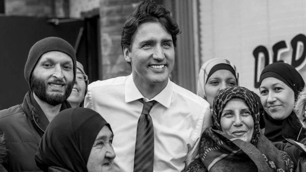 Prime Minister Justin Trudeau, lauded as a global champion today for refugees by UNHCR, poses with Canadian Syrian Newcomers outside The Depanneur in Toronto. Newcomer Kitchen is a popular pop-up featuring Syrian home-made dishes prepared by Syrian Newcomer women. This image courtesy of the feature documentary Shway Shway: The Newcomer Kitchen.