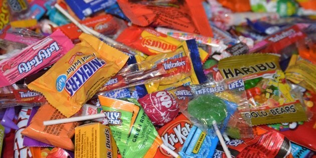 A large pile of mixed candy from trick or treating on Halloween night.