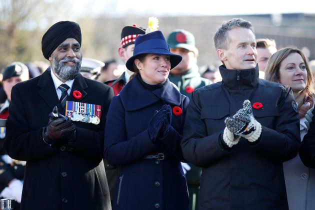 Defence Minister Harjit Sajjan watches a parade with Sophie Gregoire Trudeau and Veterans Affairs Minister Seamus O'Regan.