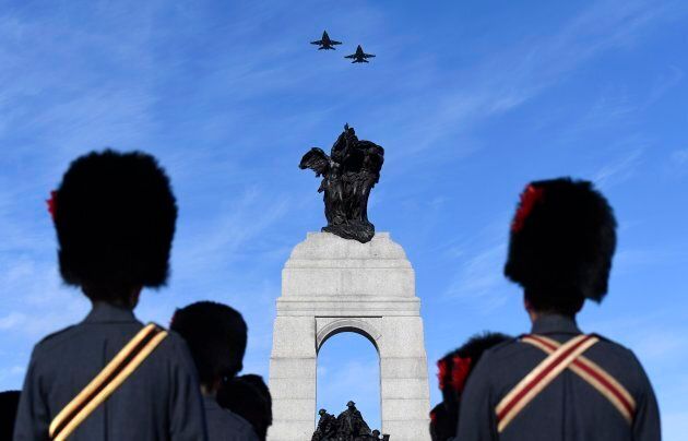 Royal Canadian Air Force CF-18 Hornets fly over the National War Memorial during the National Remembrance Day Ceremony in Ottawa.