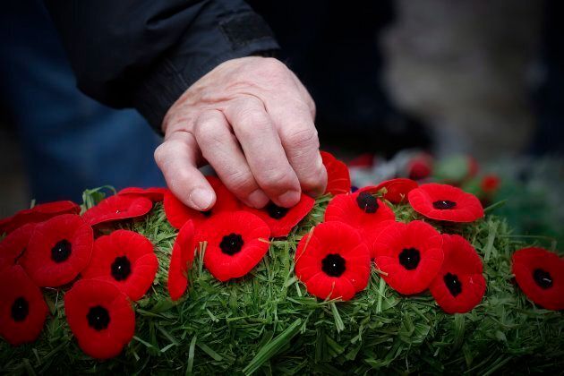 Poppies are placed on a wreath at a cenotaph during a Remembrance Day service in Winnipeg.