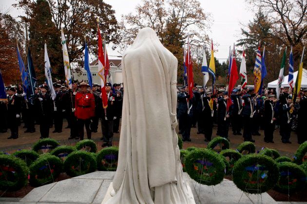 Military, RCMP, cadets and people look on at the Vimy War Memorial where wreaths lay during the Remembrance Day ceremony at Veterans Memorial Park.