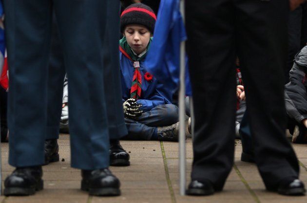 A young boy joins in a moment of silence during the Remembrance Day ceremony at Veterans Memorial Park.