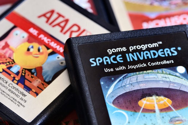 Close-up photos of vintage Atari 2600 video game cartridges including Space Invaders, Mrs Pac-Man, Pole Position and Kangaroo.