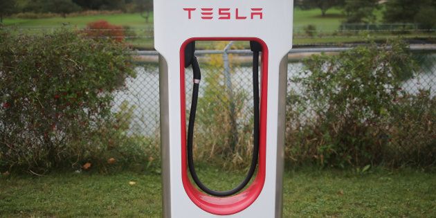 A Tesla electric vehicle charger is seen on a river bank at the edge of a parking lot in Kitchener, Ont., Oct. 13, 2017.