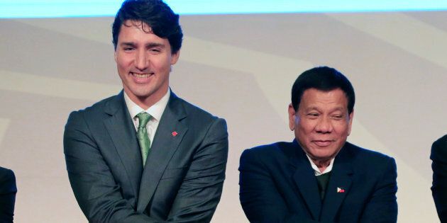 Prime Minister Justin Trudeau holds hands with Philippines' President Rodrigo Duterte during the ASEAN summit in Manila on Nov. 14, 2017.
