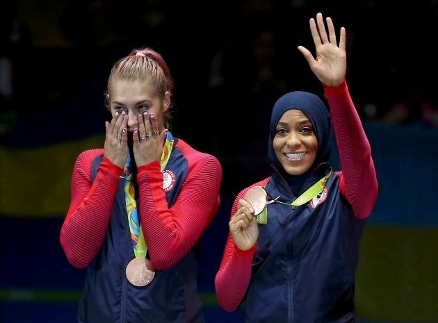 Team U.S.A. member Ibtihaj Muhammad and Dagmara Wozniak celebrate winning the bronze medal at the 2016 Rio Olympics on Aug. 13, 2016.