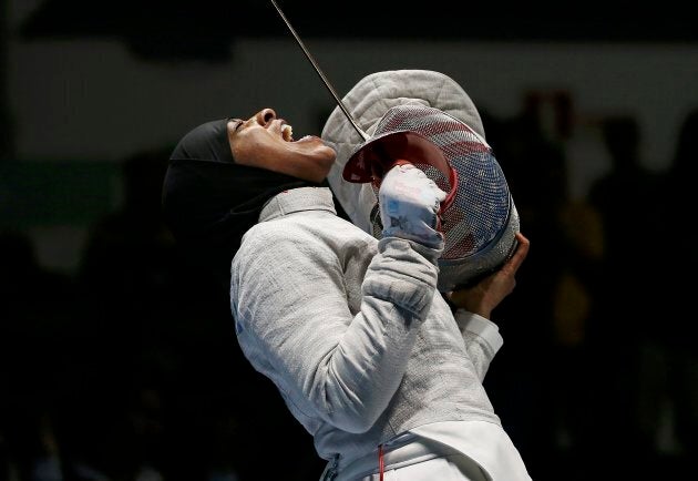 Ibtihaj Muhammad celebrates after advancing to the women's sabre team semifinals at the 2016 Rio Olympics on Aug. 13, 2016.