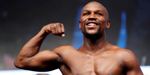 Undefeated boxer Floyd Mayweather Jr. of the U.S. poses on the scale during his official weigh-in at T-Mobile Arena in Las Vegas, Nev. on Aug. 25, 2017.