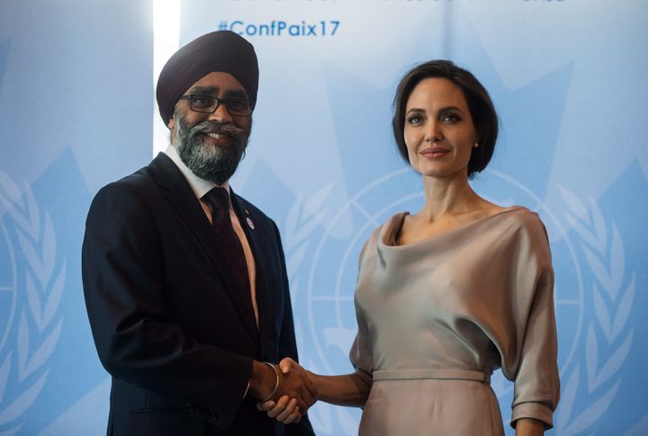 Defence Minister Harjit Sajjan, left, and UNHCR Special Envoy Angelina Jolie pose for photos before her keynote address at the 2017 United Nations Peacekeeping Defence Ministerial conference in Vancouver on Wednesday.