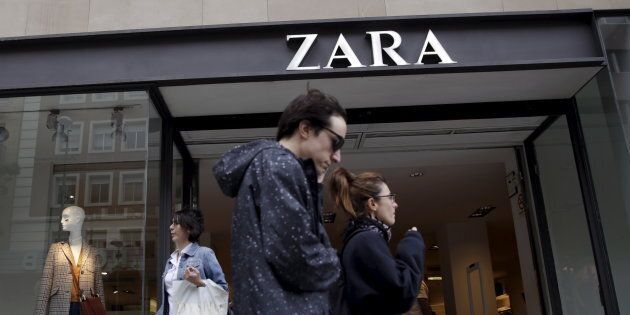 People walk past a Zara store in central Madrid, Spain, Sept. 16, 2015. Workers in Turkey who stitched pleas for help into clothing sold by retailer Zara are