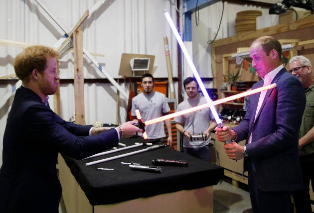 Prince Harry and Prince William try out lightsabers during a tour of the Star Wars sets at Pinewood studios in April 2016 in Iver Heath, England.