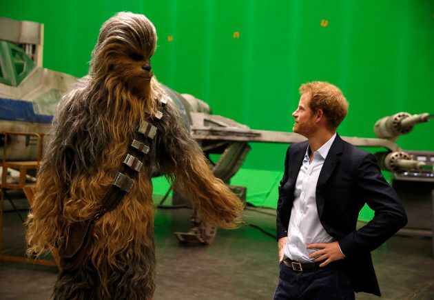 Prince Harry meets Chewbacca during a visit to the Star Wars film set at Pinewood Studios in April 2016.