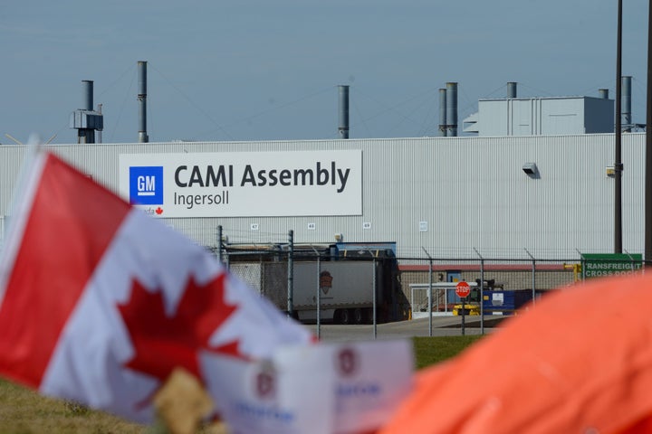 A Canadian flag flies while workers represented by Unifor are on the picket lines of the General Motors CAMI Assembly plant in Ingersoll, Ont. on Saturday, Oct. 7, 2017.