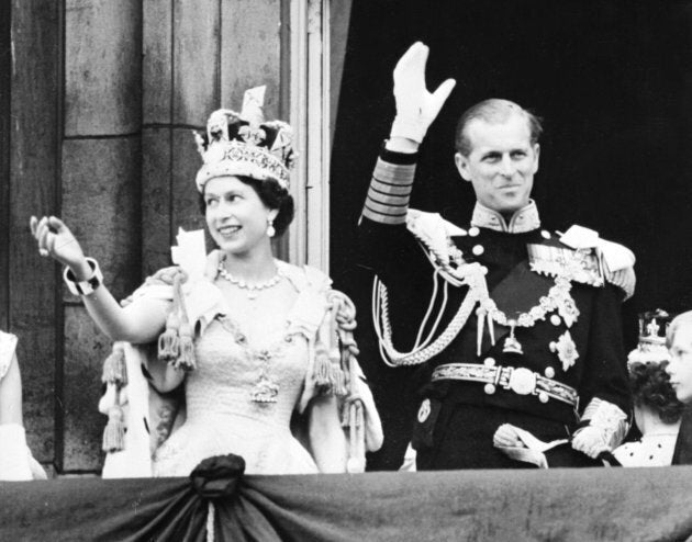 Queen Elizabeth II accompanied by Prince Philip waves to the crowd in June 1953 after being crowned solemnly at Westminter Abbey.