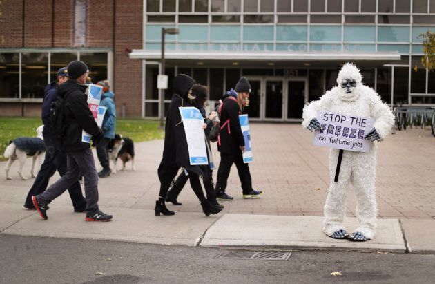 An instructor is dressed up as a Yeti while she walks the picket line at the East York Centennial College campus.