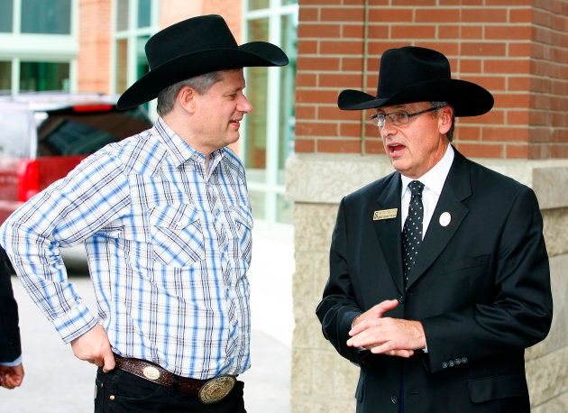 Canadian Prime Minister Stephen Harper (L) is greeted by Stampede president David Chalack during the Calgary Stampede in Calgary, Alta., July 3, 2009.