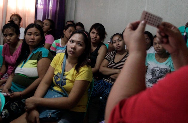 Women listen during a family planning lecture by a Likhaan NGO health worker at a reproductive health clinic in Tondo, metro Manila, Philippines on Jan. 12, 2016