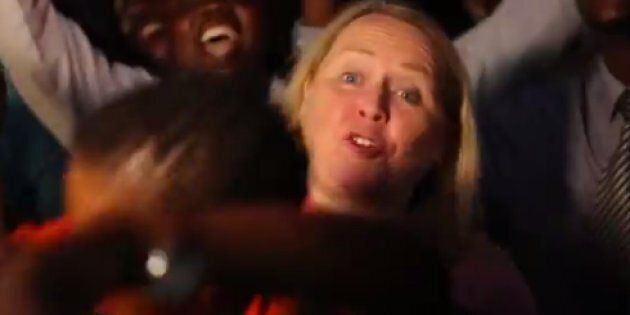 A screengrab from a CBC News report shows correspondent Margaret Evans barely able to stand in front of the camera as crowds celebrate Robert Mugabe's resignation.
