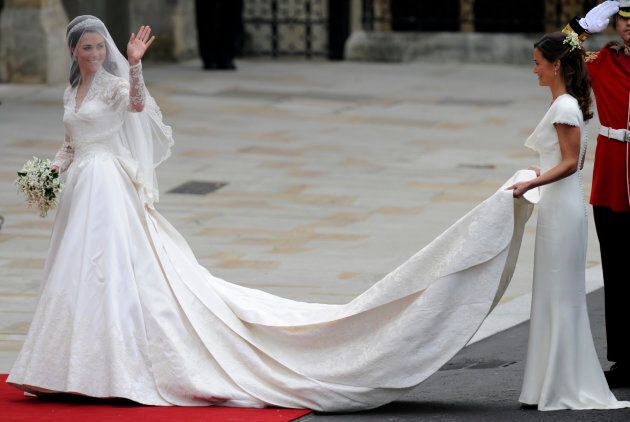 Kate Middleton waves as she arrives at the West Door of Westminster Abbey in London for her wedding to Prince William, on April 29, 2011.