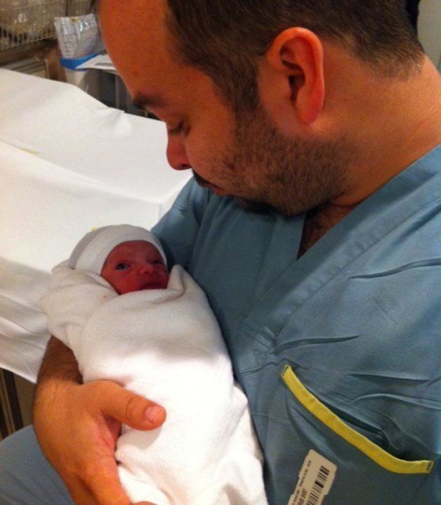 Jon holding Kaia for the first time.