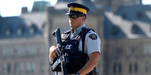 An armed RCMP officer stands on Parliament Hill, a day after an RCMP incident involving Aaron Driver in Strathroy, Ont., on Thursday, Aug. 11, 2016 in Ottawa.